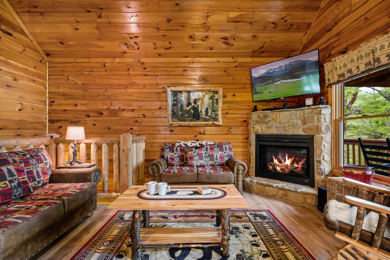 Living room with fireplace, TV, and cozy couch and loveseat Living room with fireplace, TV, and cozy couch and loveseat
