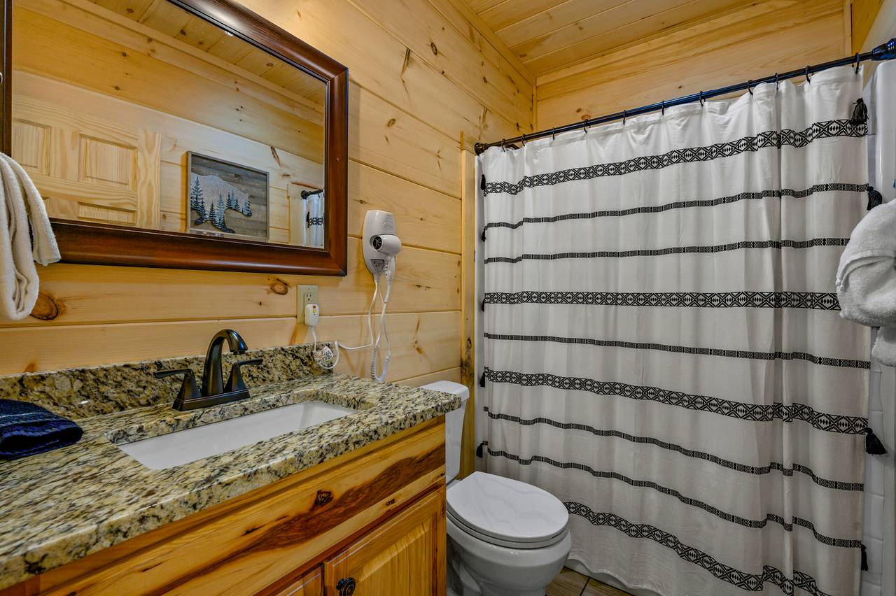 Bed 2: En-suite full bathroom with tub and shower combo Bed 2: En-suite full bathroom with tub and shower combo