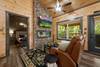 Living room with fireplace, TV, and reclining sofa Living room with fireplace, TV, and reclining sofa