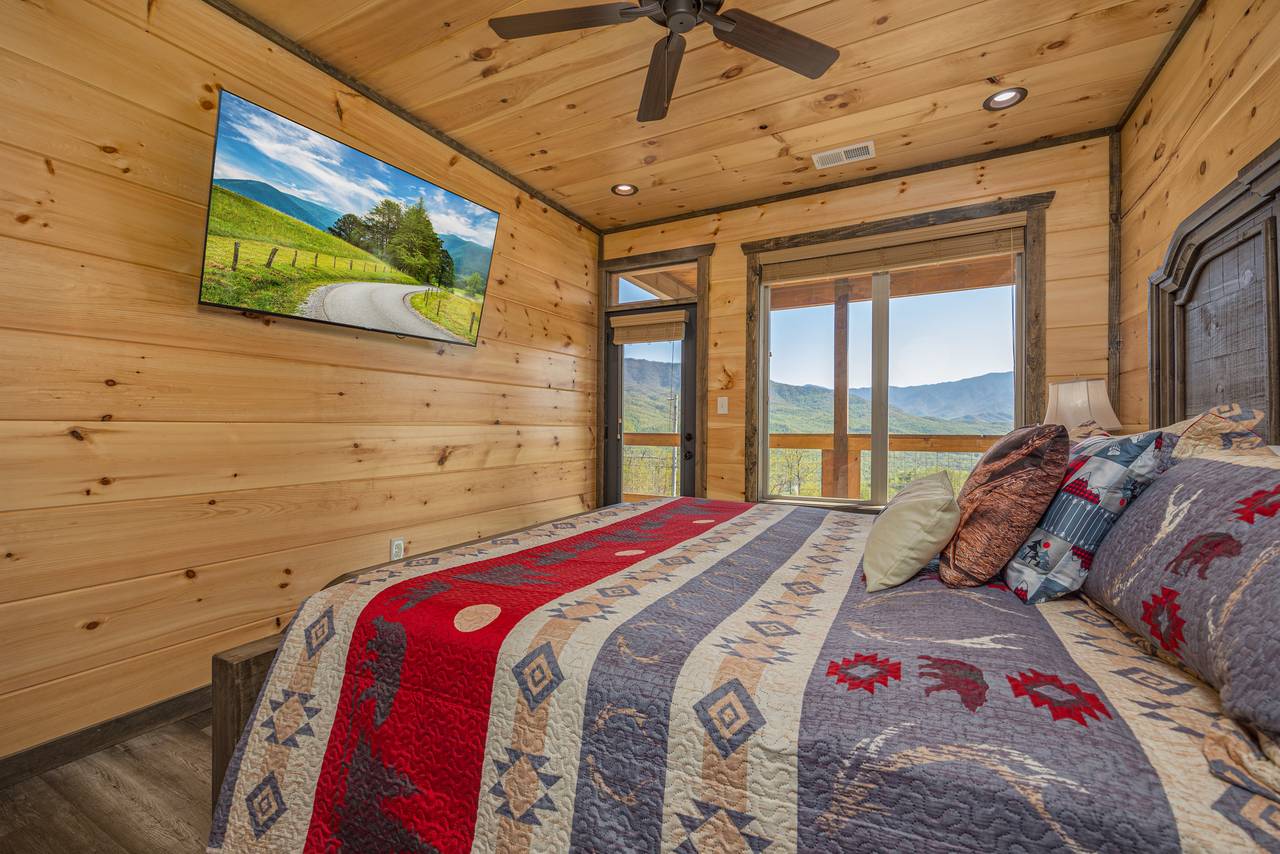 Bed 2: Upper level, king, deck access, TV, & ensuite half bath Bed 2: Upper level, king, deck access, TV, & ensuite half bath