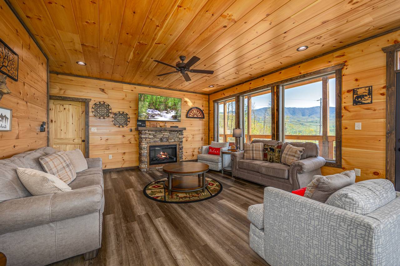 Spacious living room w/ couch, armchair, loveseat, TV & fireplac Spacious living room w/ couch, armchair, loveseat, TV & fireplac