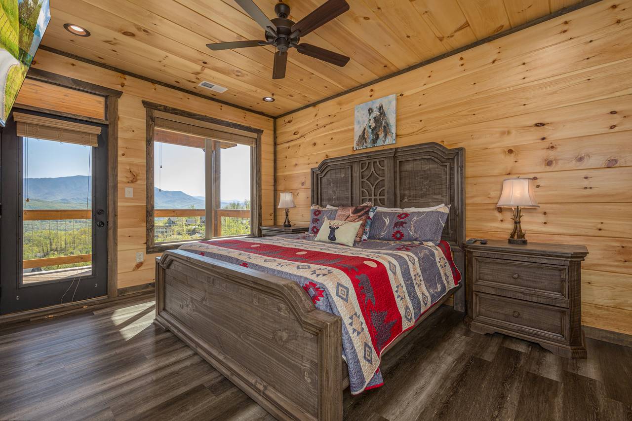 Bed 2: Upper level, king, deck access, TV, & ensuite half bath Bed 2: Upper level, king, deck access, TV, & ensuite half bath