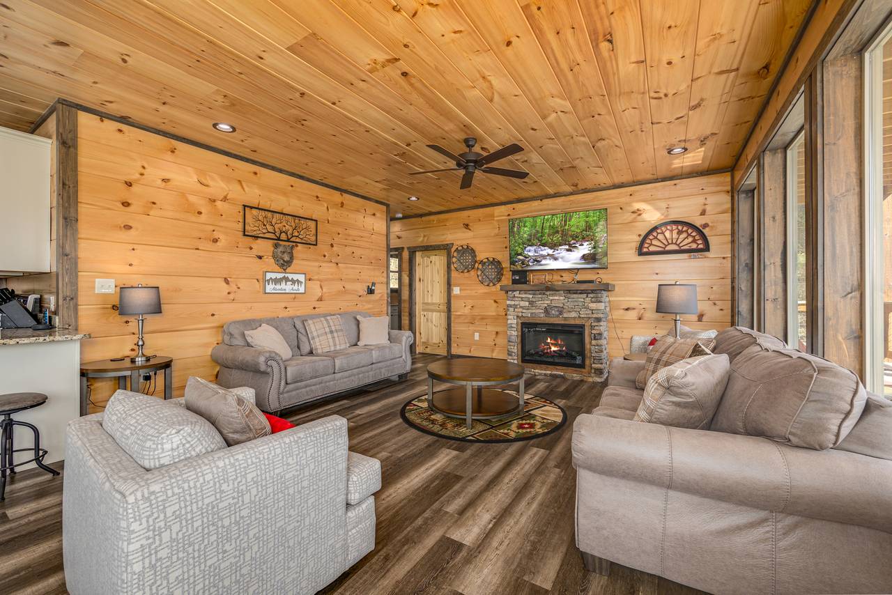 Spacious living room w/ couch, armchair, loveseat, TV & fireplac Spacious living room w/ couch, armchair, loveseat, TV & fireplac