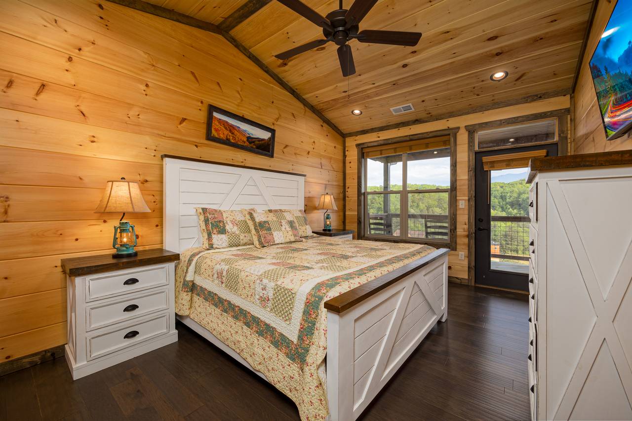 Bed 2: Upper level, king, TV, ensuite full bath, & deck access Bed 2: Upper level, king, TV, ensuite full bath, & deck access