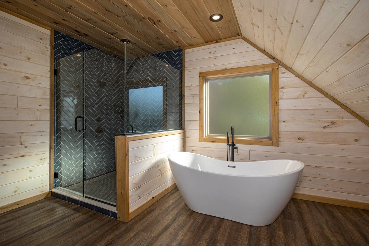 Upper level en-suite full bathroom with soaking tub and shower Upper level en-suite full bathroom with soaking tub and shower