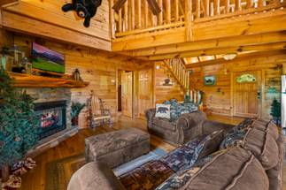 Living room with sleeper sofa, arm chair, gas fireplace, & TV Living room with sleeper sofa, arm chair, gas fireplace, & TV