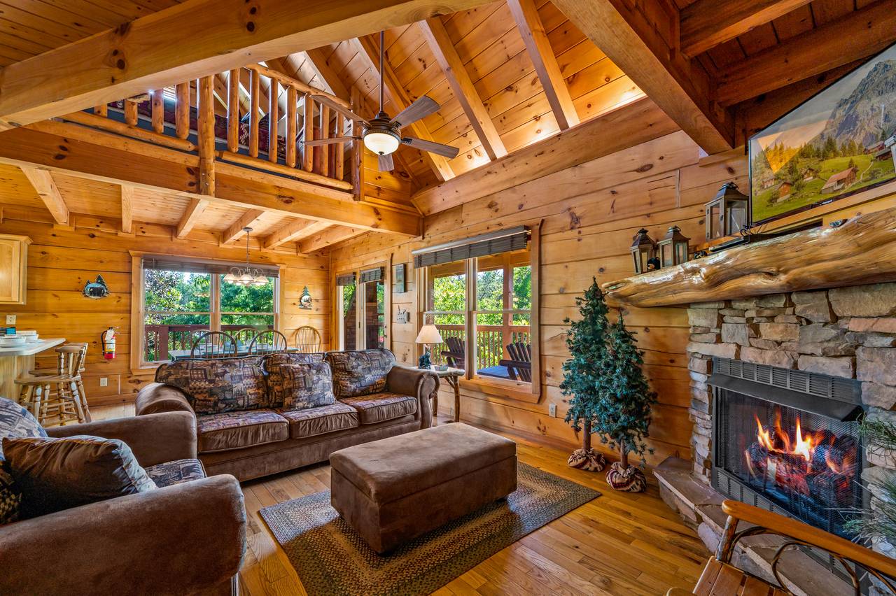 Living room with sleeper sofa, arm chair, gas fireplace, & TV Living room with sleeper sofa, arm chair, gas fireplace, & TV