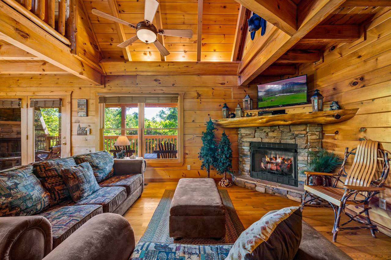 Living room with sleeper sofa, arm chair, gas fireplace, & TV Living room with sleeper sofa, arm chair, gas fireplace, & TV