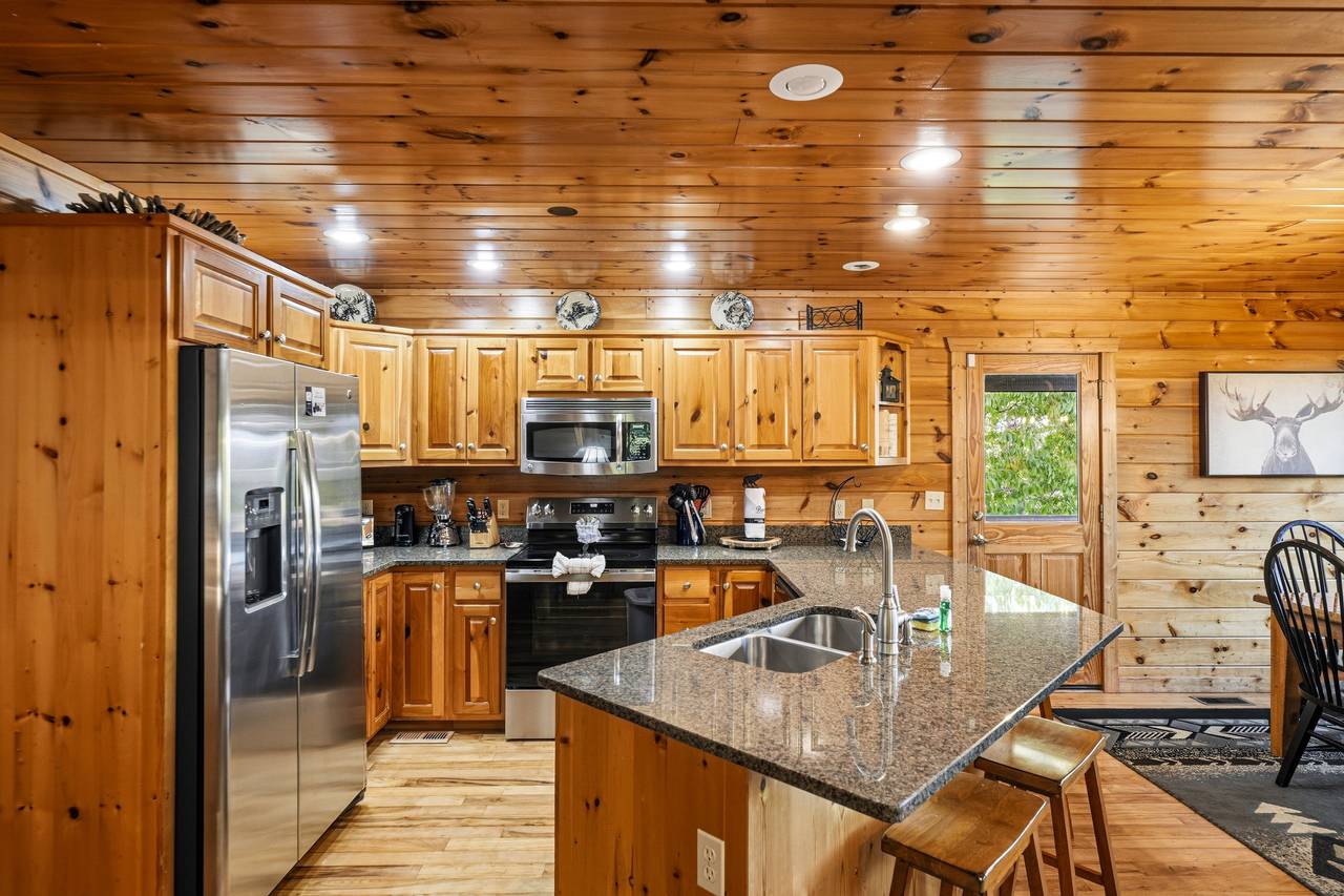 Kitchen with stainless appliances & bar seating for 4 Kitchen with stainless appliances & bar seating for 4