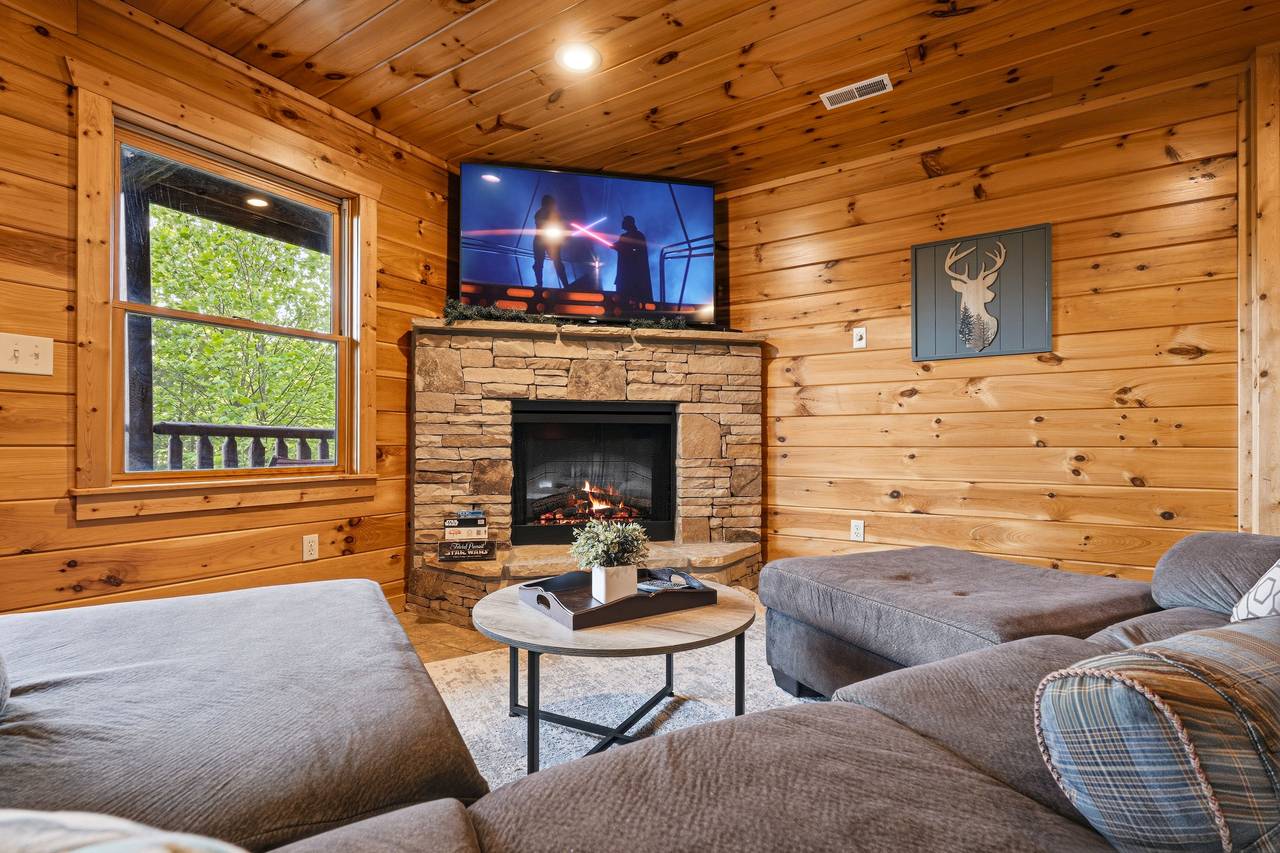 Lower level media room with sectional & fireplace Lower level media room with sectional & fireplace
