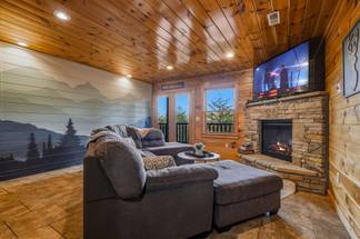 Lower level media room with sectional & fireplace Lower level media room with sectional & fireplace