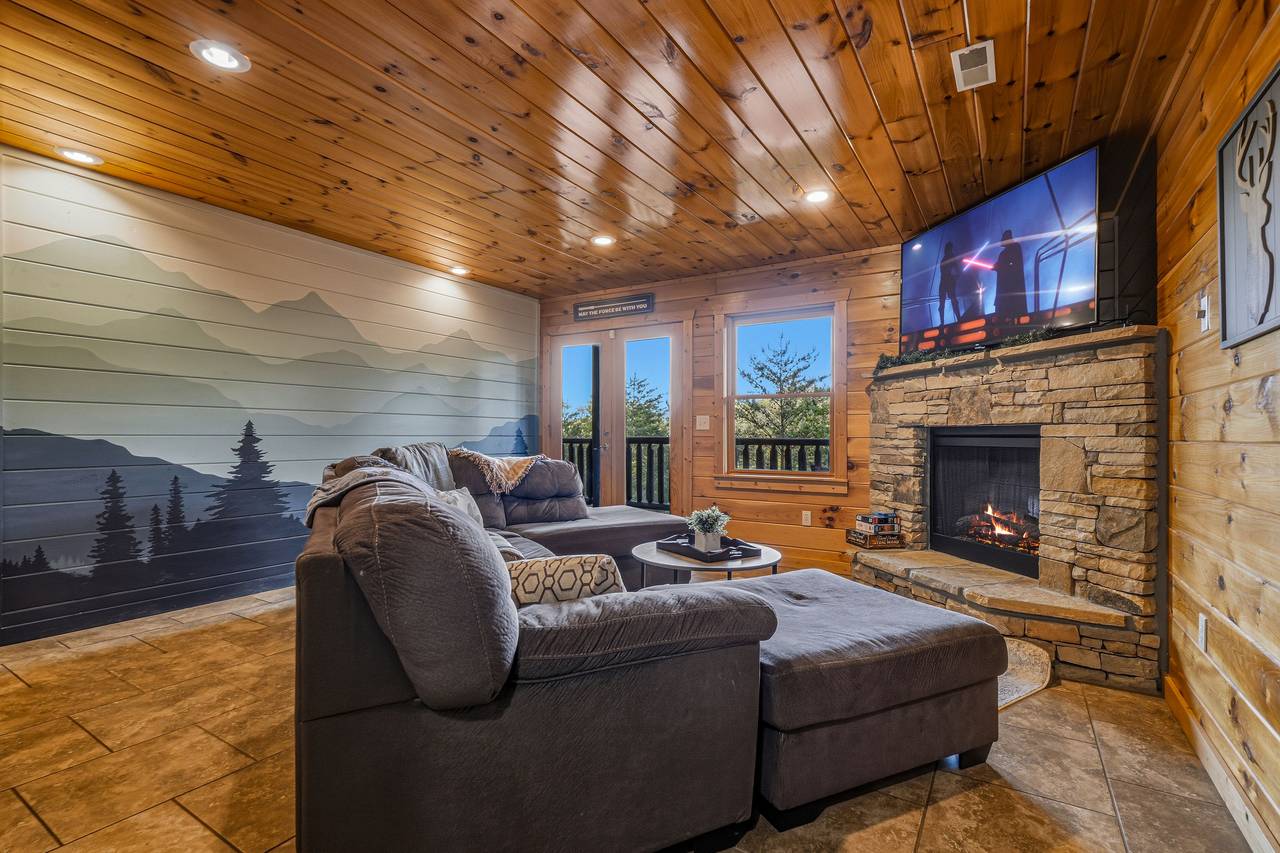 Lower level media room with sectional & fireplace Lower level media room with sectional & fireplace