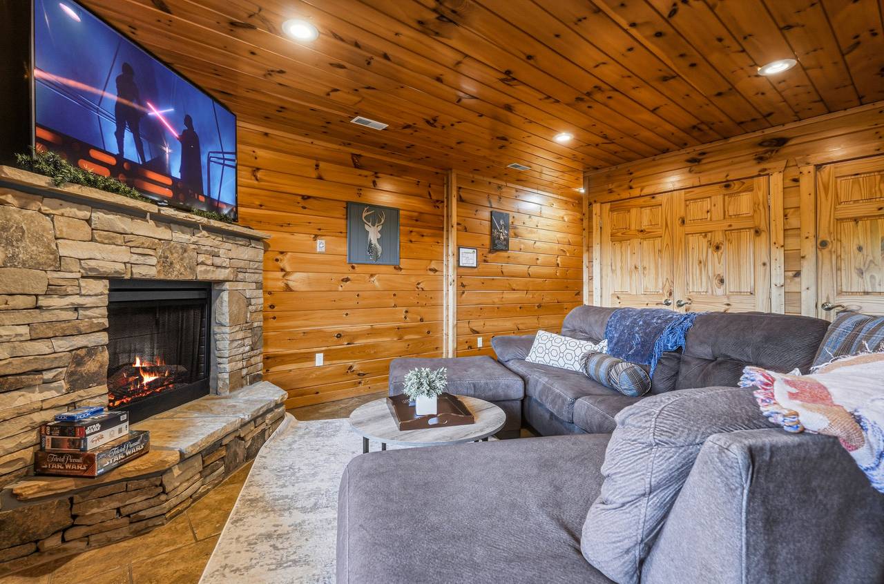 Lower level media room with sectional & fireplace Lower level media room with sectional & fireplace