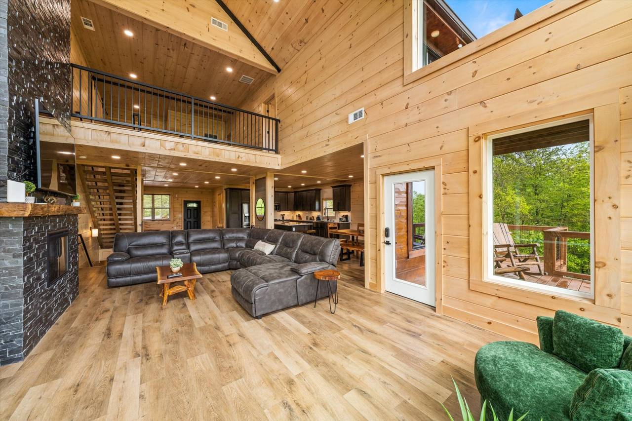 Spacious living room w/plush sectional sofa, gas fireplace, & TV Spacious living room w/plush sectional sofa, gas fireplace, & TV