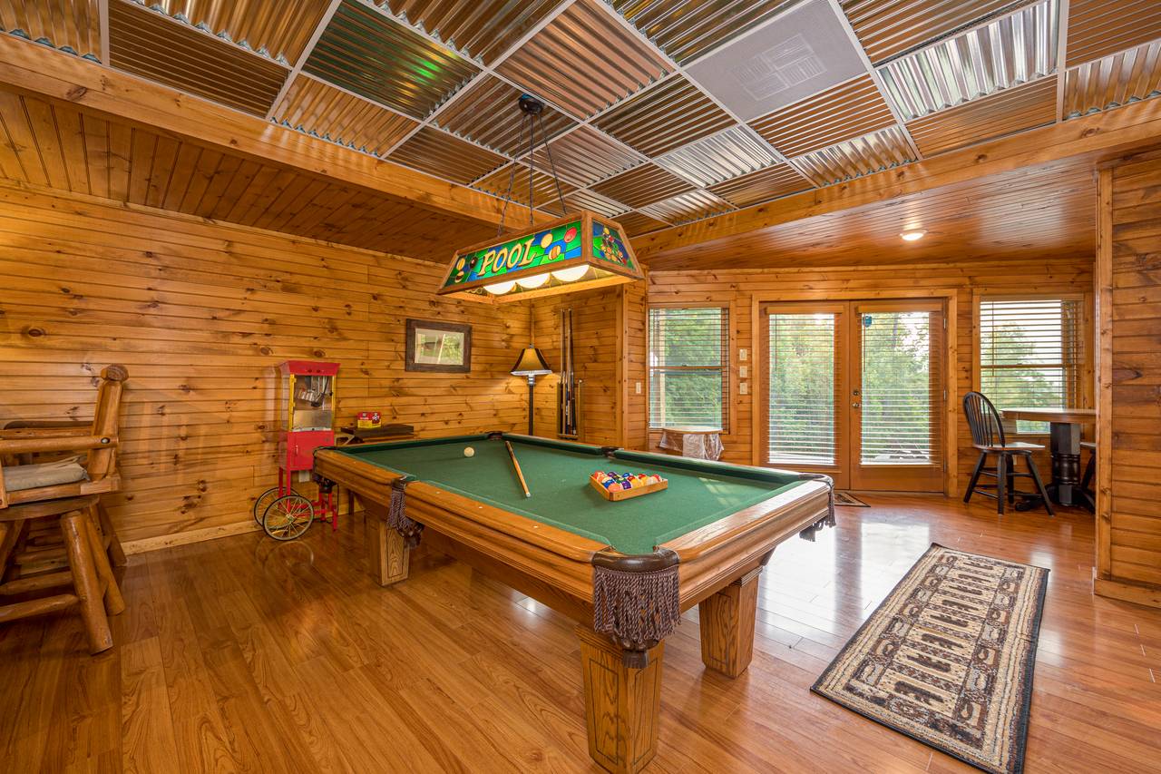 Lower level media room with sofa, TV, and pool table Lower level media room with sofa, TV, and pool table
