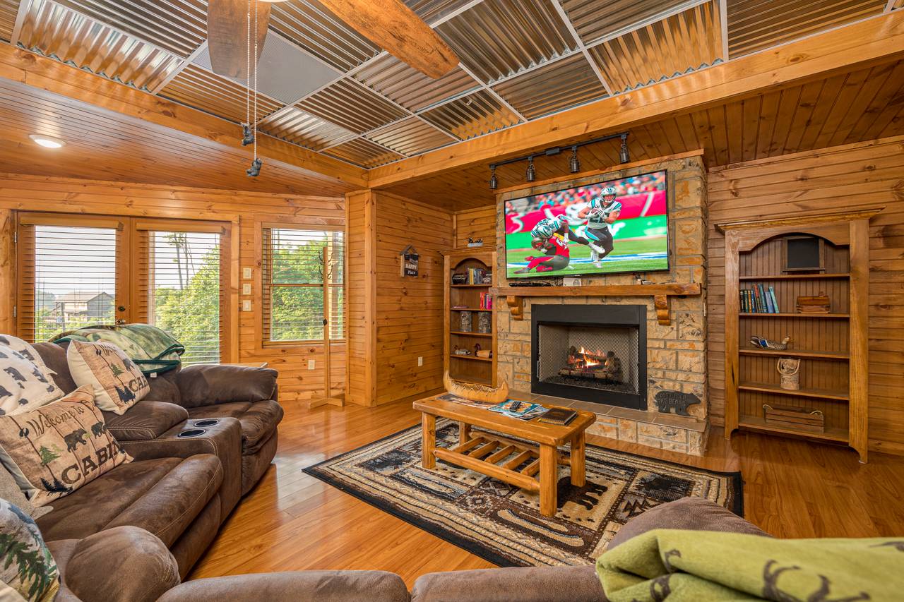 Lower level media room with sofa, TV, and pool table Lower level media room with sofa, TV, and pool table