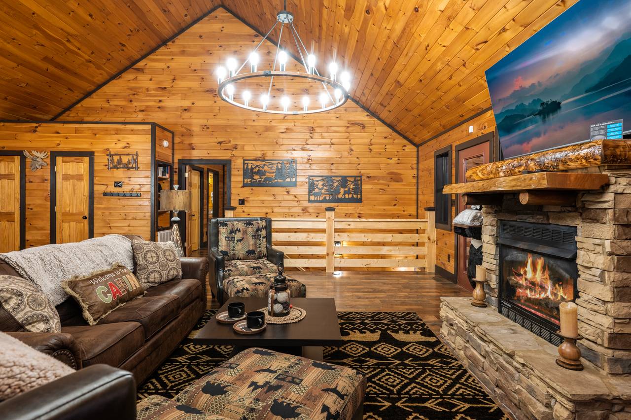 Living room on entry level with sleeper sofa, fireplace, & TV Living room on entry level with sleeper sofa, fireplace, & TV