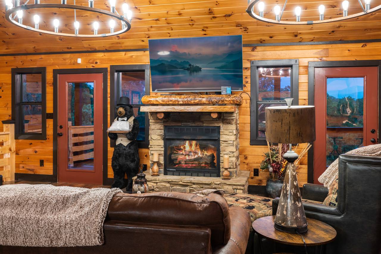 Living room on entry level with sleeper sofa, fireplace, & TV Living room on entry level with sleeper sofa, fireplace, & TV