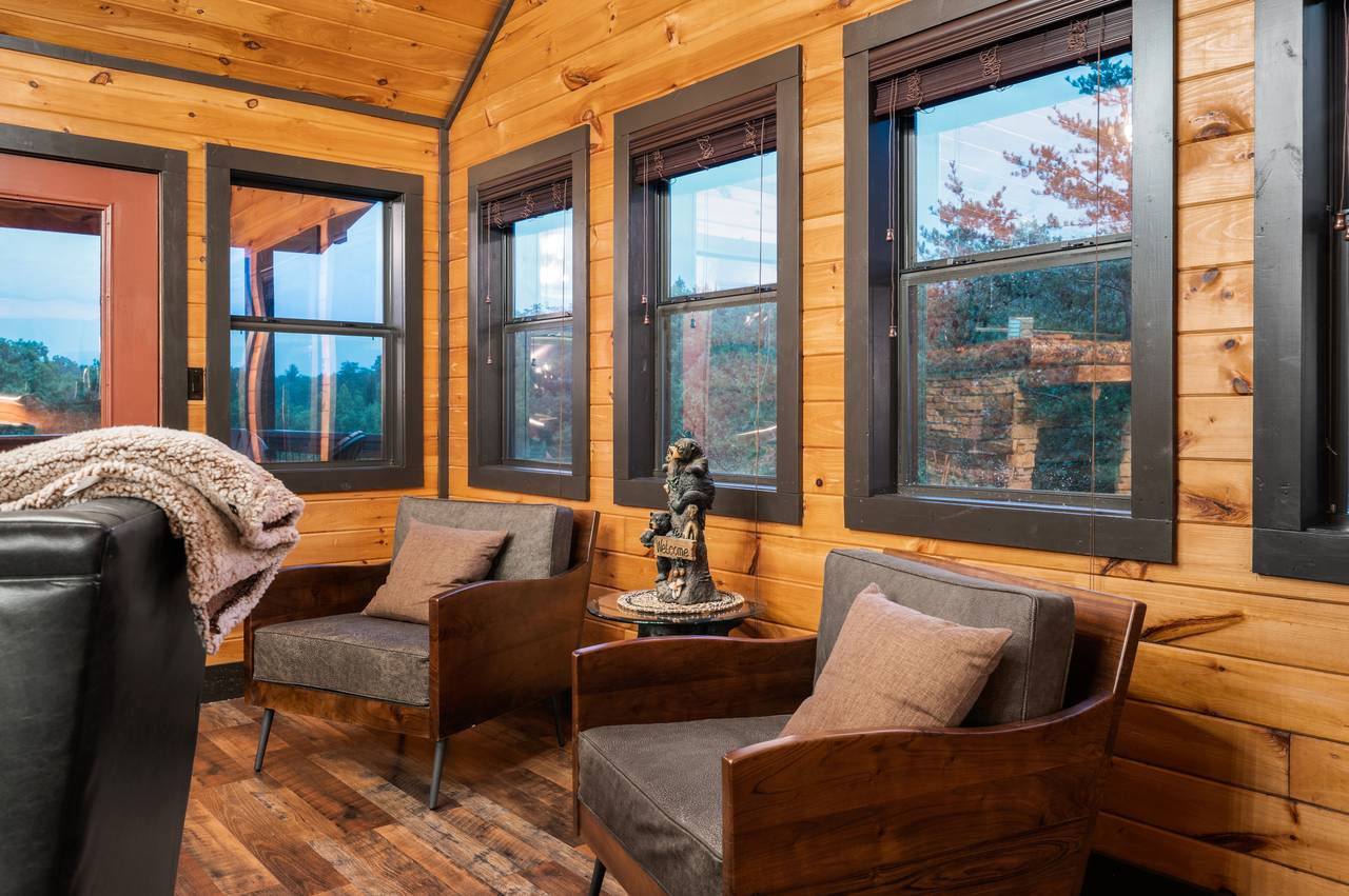 Living room on entry level with sleeper sofa, fireplace, & TV Living room on entry level with sleeper sofa, fireplace, & TV