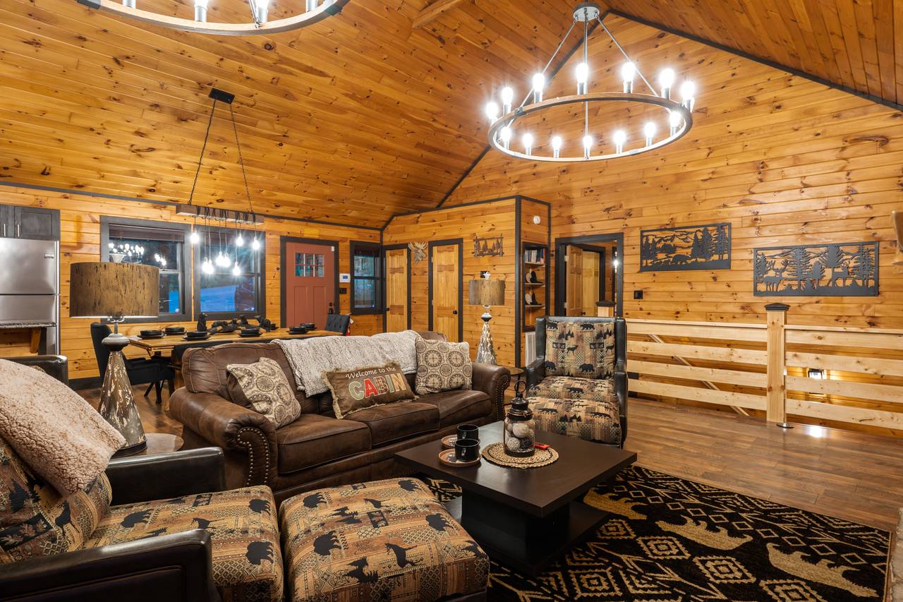 Living room on entry level with sleeper sofa, fireplace, & TV Living room on entry level with sleeper sofa, fireplace, & TV