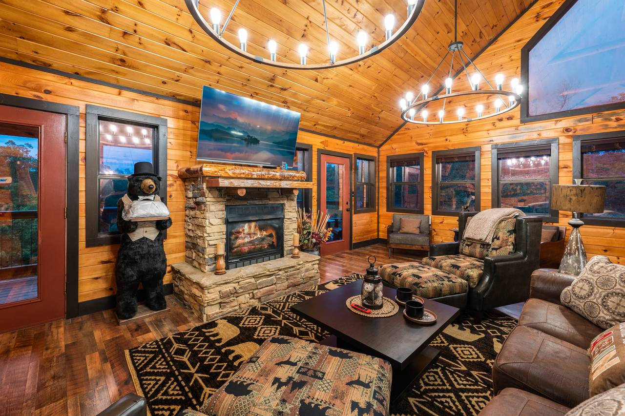 Living room on entry level with sleeper sofa, fireplace, & TV Living room on entry level with sleeper sofa, fireplace, & TV