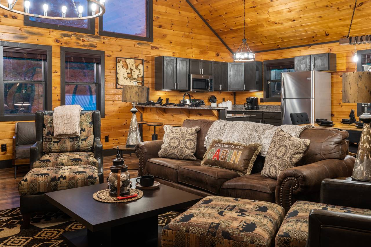Living room on entry level with sleeper sofa, fireplace, & TV Living room on entry level with sleeper sofa, fireplace, & TV