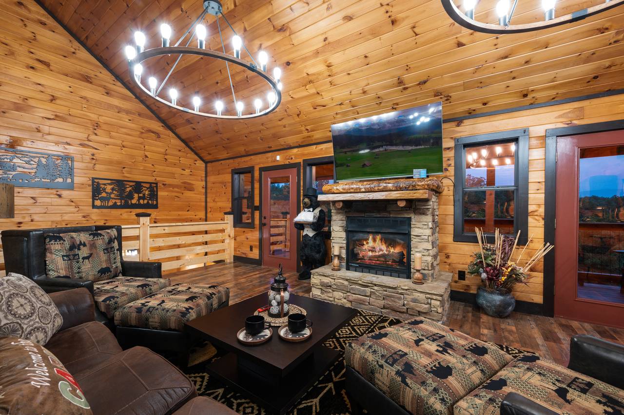 Living room on entry level with sleeper sofa, fireplace, & TV Living room on entry level with sleeper sofa, fireplace, & TV