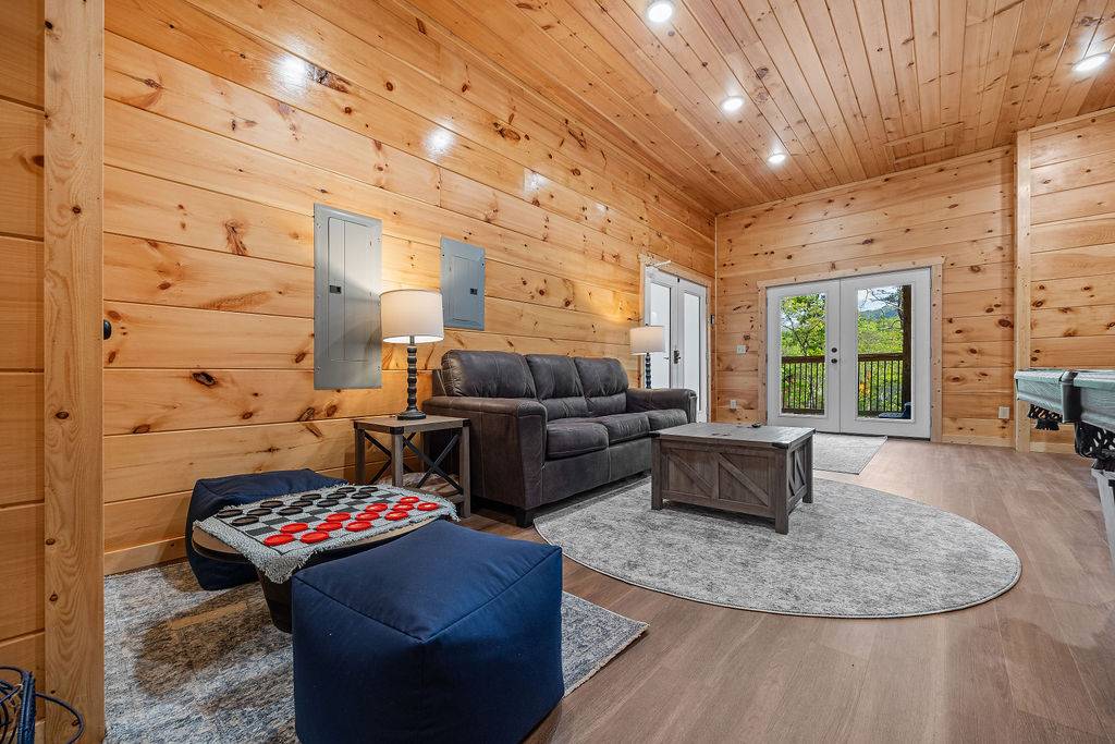 Lower level game room with comfy sofa, pool table, & air hockey