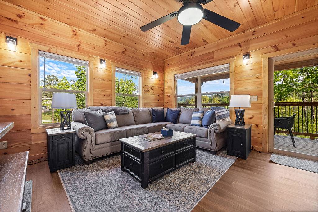 Living room with electric fireplace, TV, and wraparound sofa