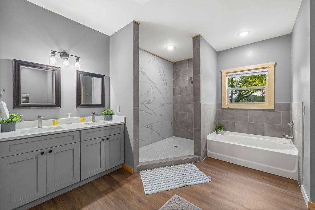 Ensuite full bath with standing shower and tub.