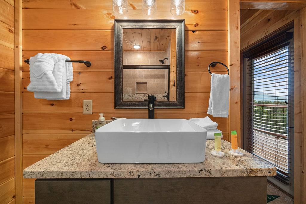 Entry level king ensuite full bathroom with standing shower