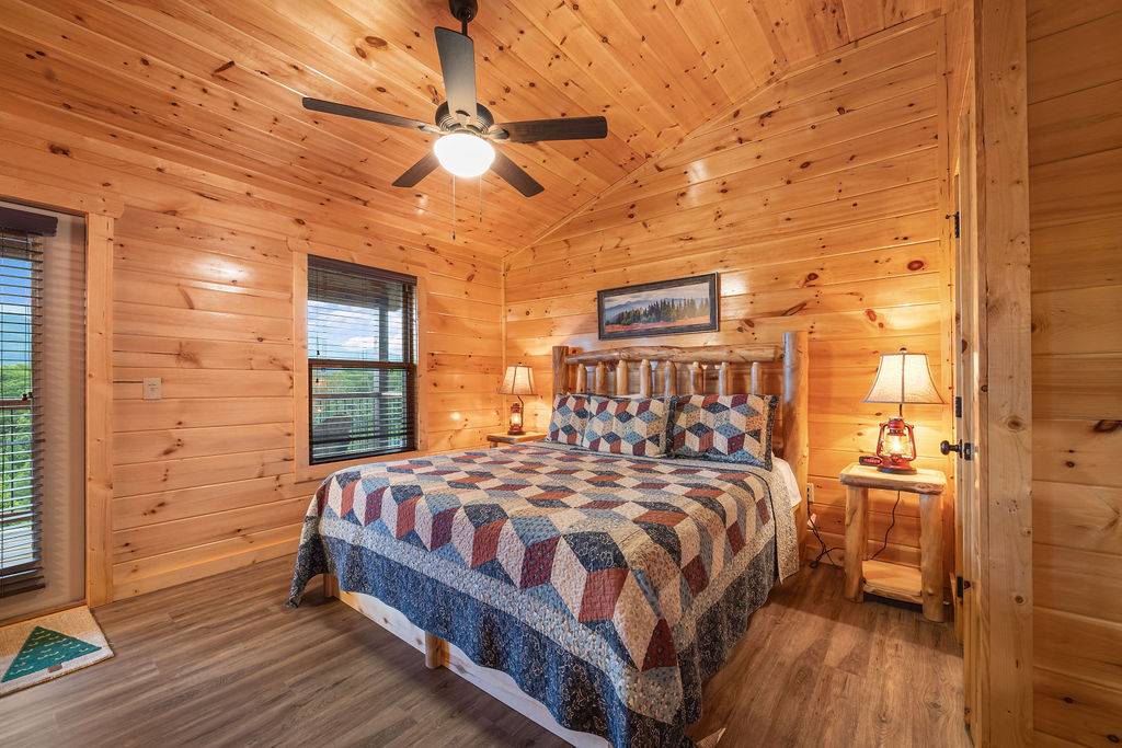 Upper level king bedroom w/deck access, TV, & ensuite bath