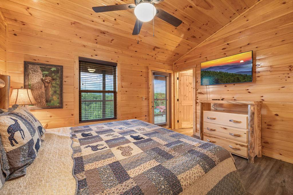 Upper level king bedroom w/deck access, TV, & ensuite bath