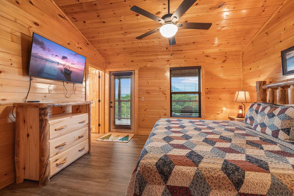 Upper level king bedroom w/deck access, TV, & ensuite bath