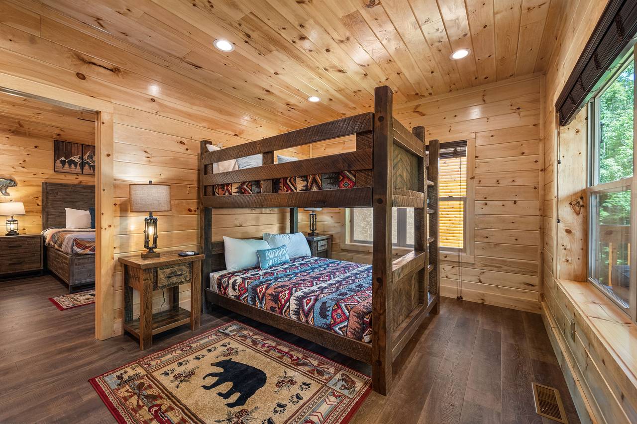 Mid-level queen over queen bunk room with arcade games Mid-level queen over queen bunk room with arcade games