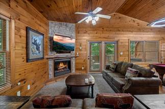 Spacious living room with TV, sleeper sofa, and fireplace Spacious living room with TV, sleeper sofa, and fireplace