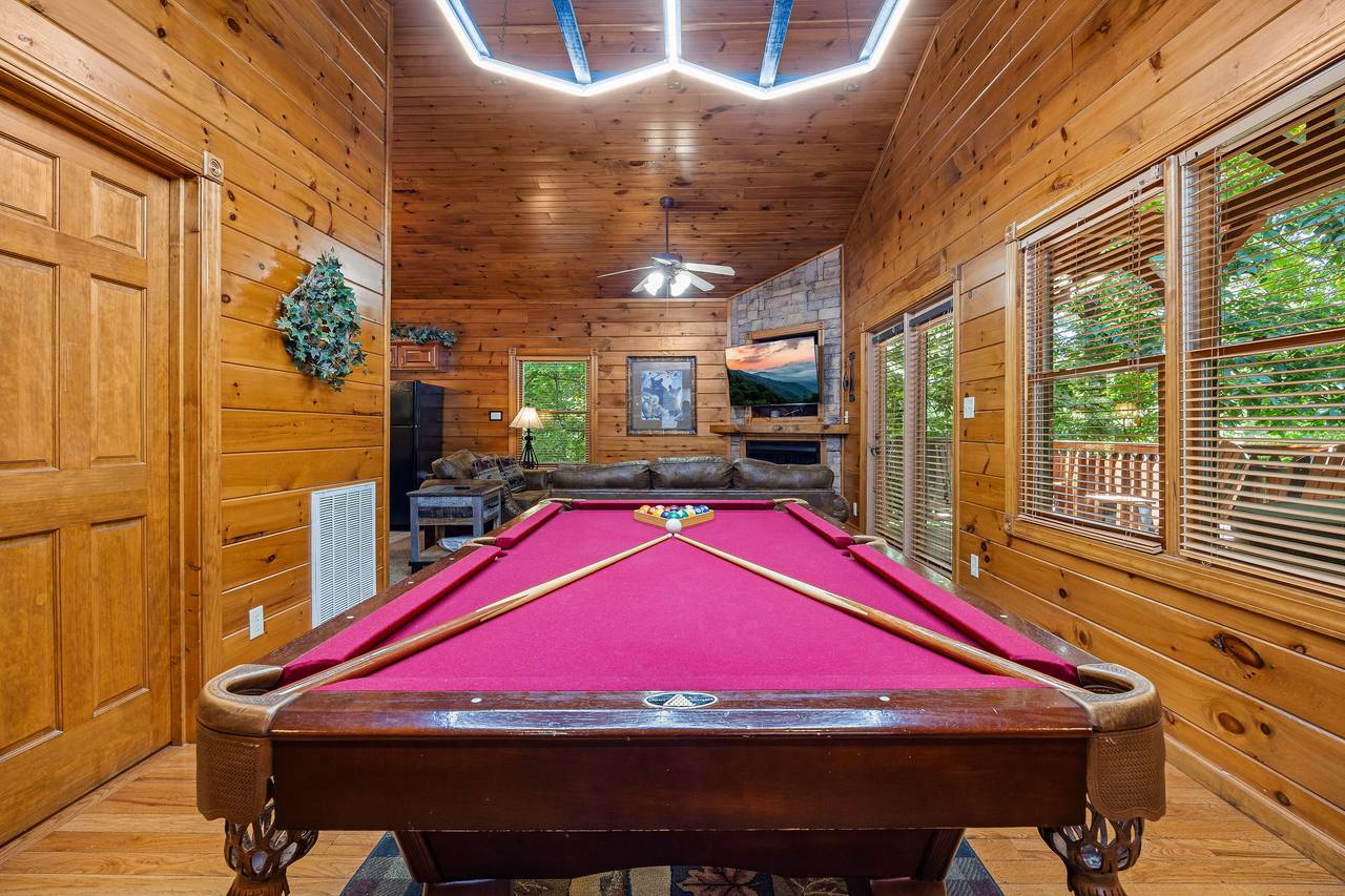 Game room with pool table, multi-cade, and air hockey. Game room with pool table, multi-cade, and air hockey.