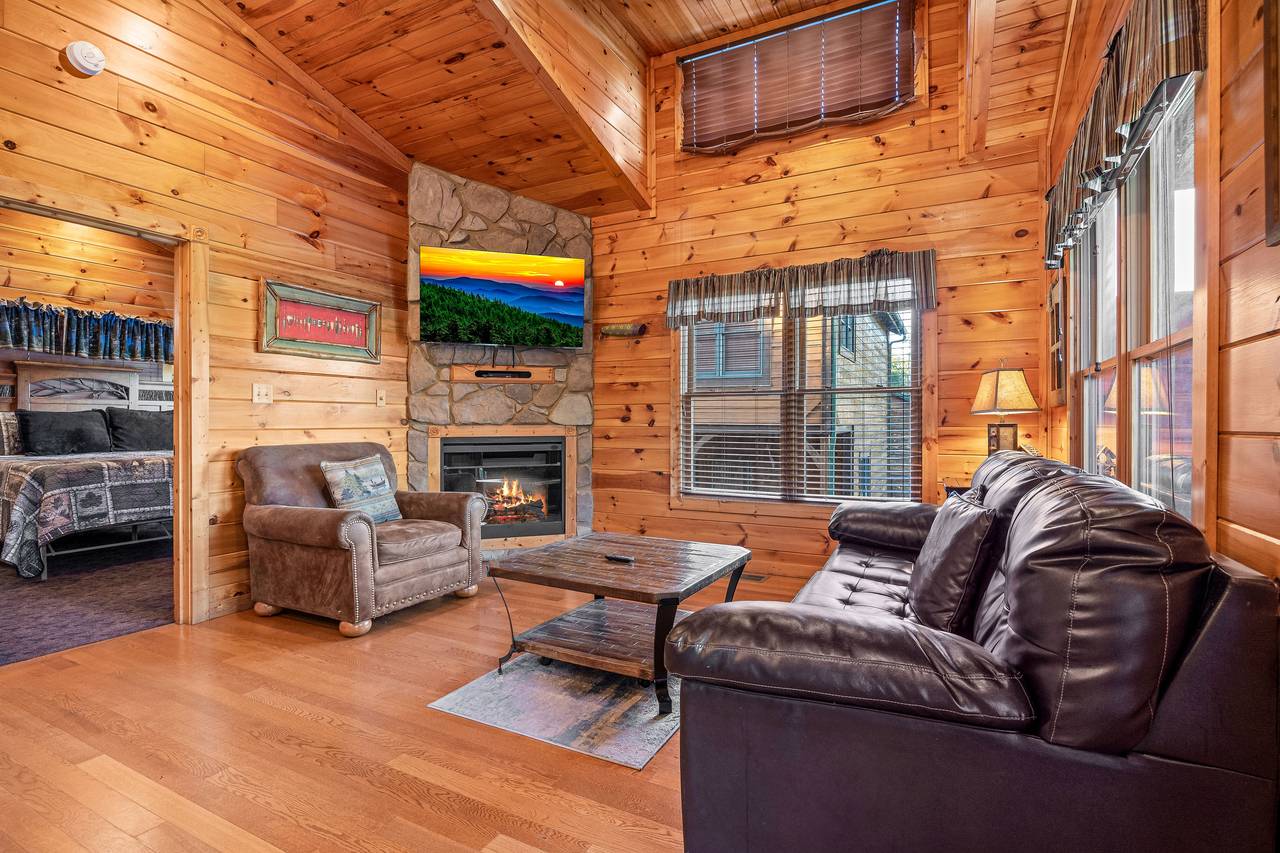 Spacious living room with sleeper sofa, fireplace, & TV. Spacious living room with sleeper sofa, fireplace, & TV.