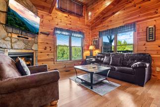 Spacious living room with sleeper sofa, fireplace, & TV. Spacious living room with sleeper sofa, fireplace, & TV.