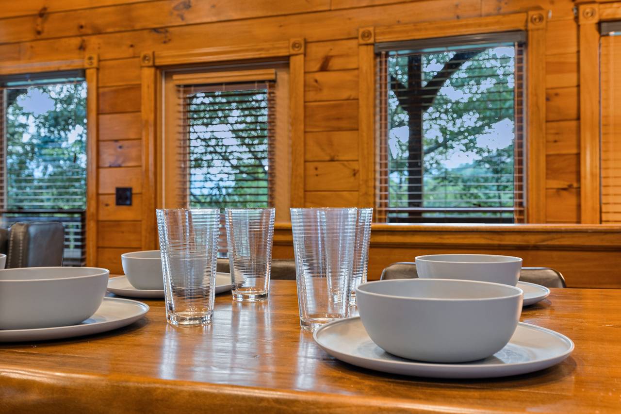 Dining area with dinner/silver-ware provided. Dining area with dinner/silver-ware provided.