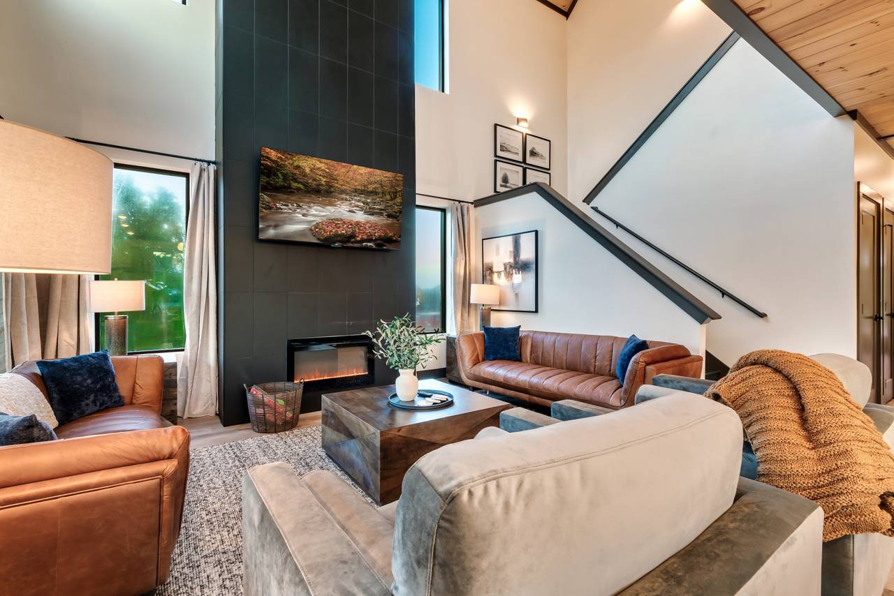 Spacious living room with fireplace, comfy seating, & TV Spacious living room with fireplace, comfy seating, & TV