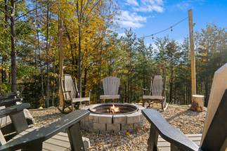 Wood fire-pit surrounded by seating for cozy evenings Wood fire-pit surrounded by seating for cozy evenings