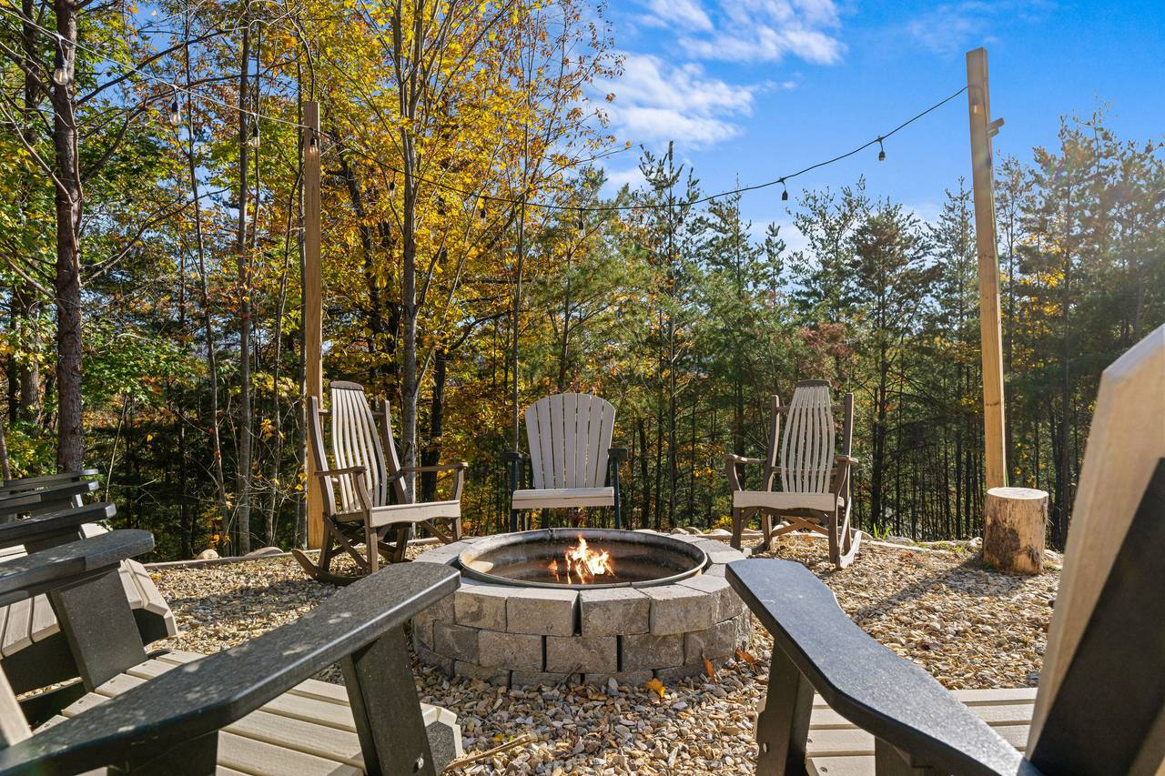 Wood fire-pit surrounded by seating for cozy evenings Wood fire-pit surrounded by seating for cozy evenings