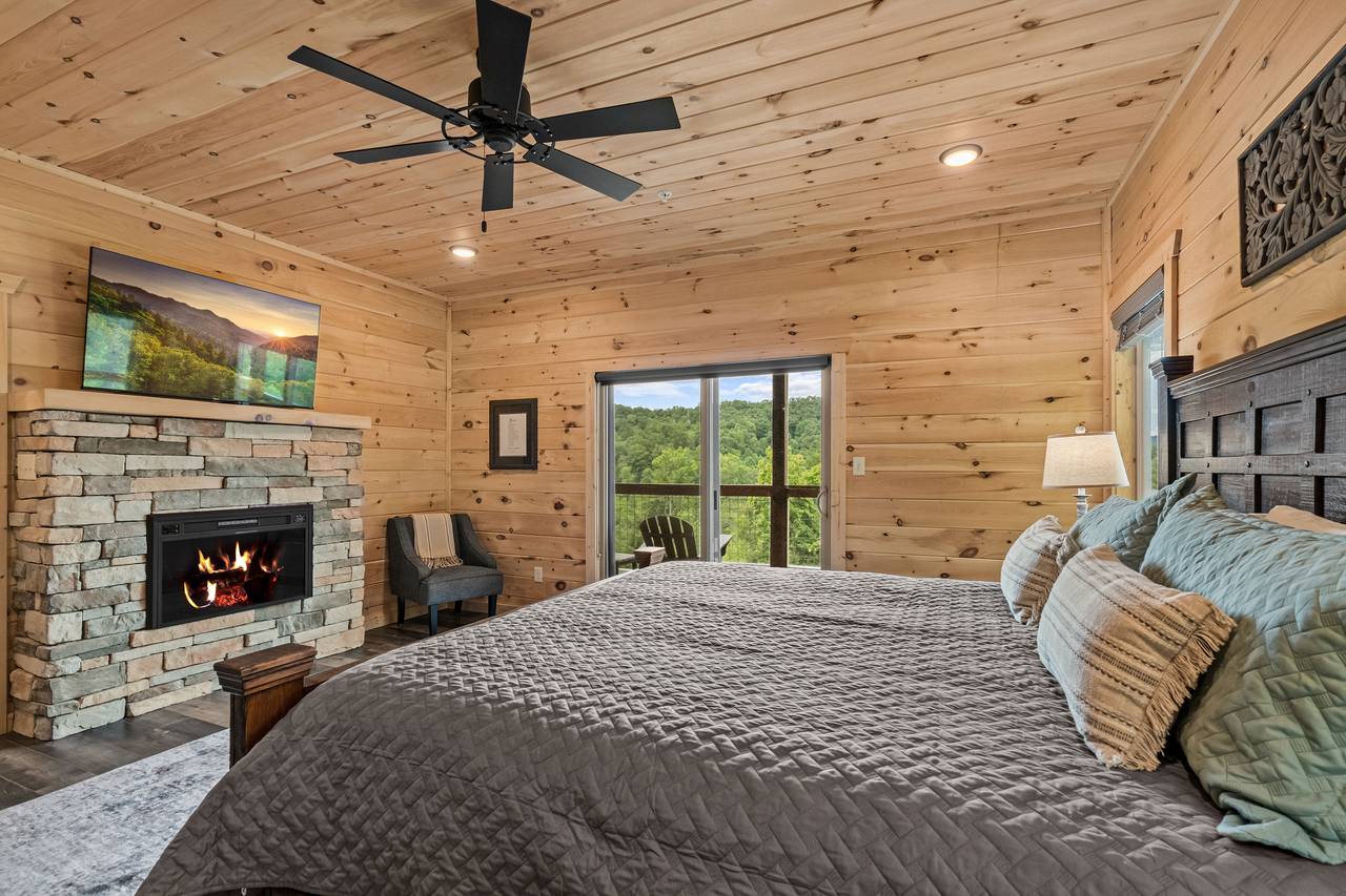Entry level king bedroom with TV, fireplace, & ensuite full bath Entry level king bedroom with TV, fireplace, & ensuite full bath