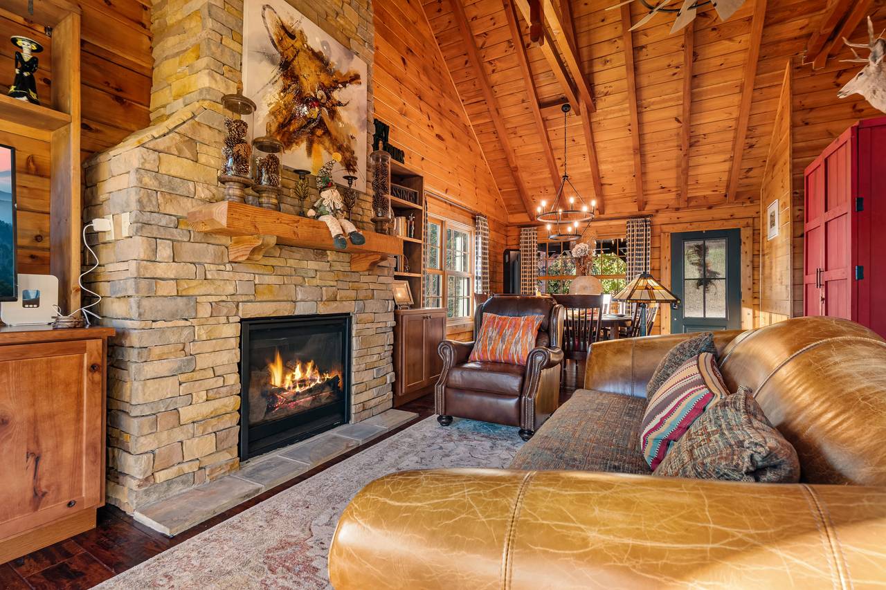Living room with gas fireplace, TV, and comfy seating. Living room with gas fireplace, TV, and comfy seating.