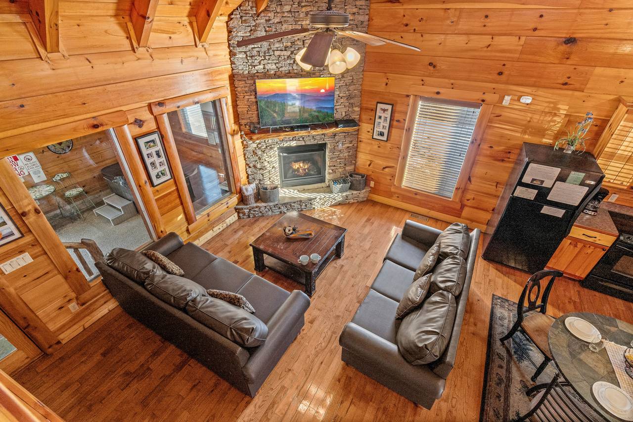 Living room with fireplacek, sleeper sofa, and TV. Living room with fireplacek, sleeper sofa, and TV.