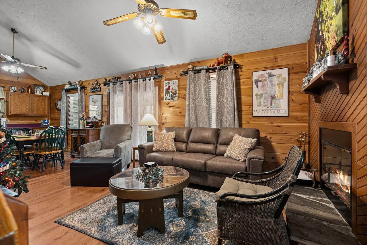 Living room with TV, comfy seating, and fireplace. Living room with TV, comfy seating, and fireplace.