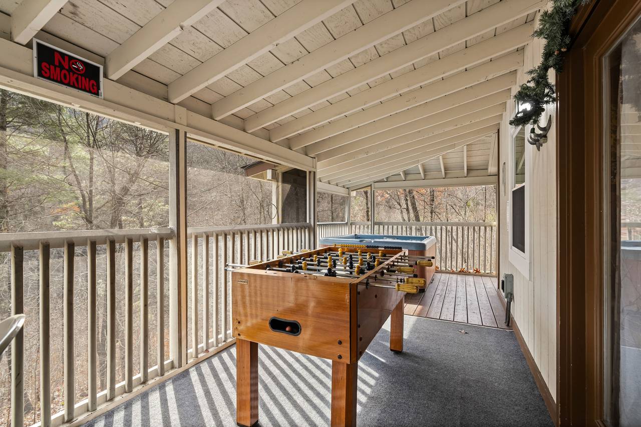 Foosball table covered on screened porch Foosball table covered on screened porch