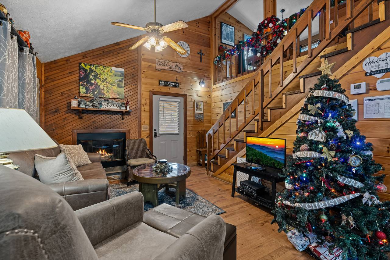 Living room with TV, comfy seating, and fireplace. Living room with TV, comfy seating, and fireplace.