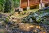 Soothing mountain stream runs beside the cabin Soothing mountain stream runs beside the cabin